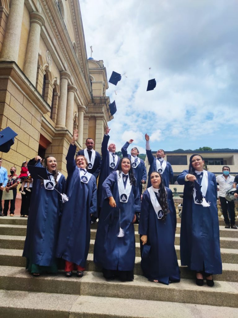 Foto de los graduandos arrojando los birretes al aire como lo es tradicional en estas ceremonias.